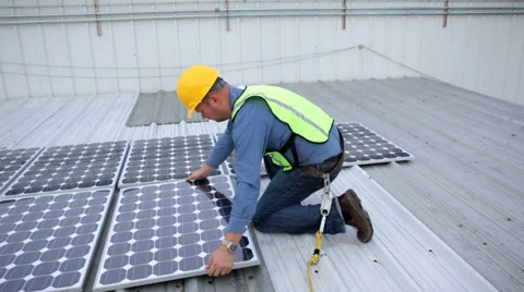 Contractor installing solar panels on rooftop Stock Footage