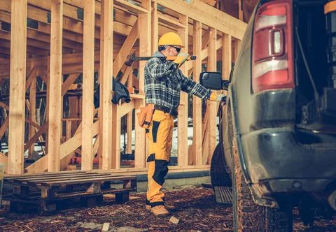 Contractor with Large Hammer and the Construction Site 写真素材