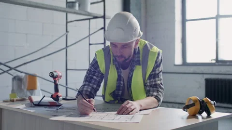 Contractor Making Notes on Technical Drawings on Construction Site Stock Footage 332249729