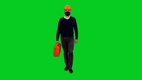 Contractor in mask and hardhat with red suitcase walking on green screen Stock Footage 131145766