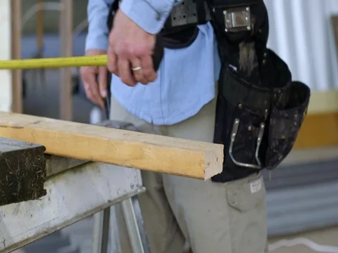 Contractor measures and marks a plank of wood in slow motion 4K Stock Footage 80405185