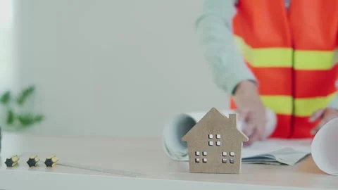 The contractor opens the blueprint of the house design that the customer want Stock Footage 139053781