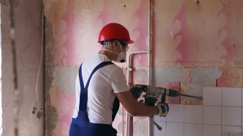 Contractor removes of ceramic tiles facing of the wall. Workman doing Video stock 197371602