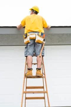 Contractor standing on ladder Stock Photos