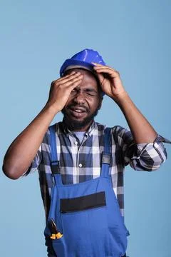 Contractor stressed by overwork feeling headache Stock Photos