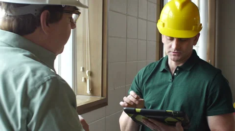 Contractor talking with Architect, holding ablet Stock Footage 49085910