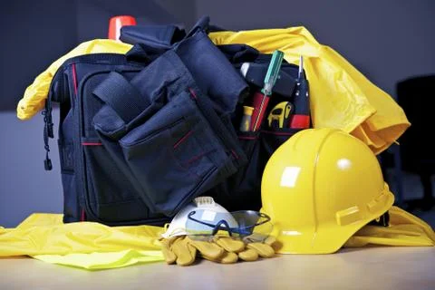 Contractor tools, rain suit, yellow helmet and tools bag. Photos