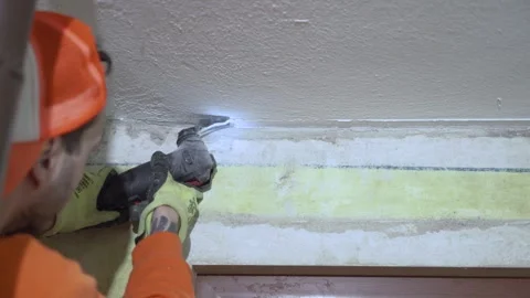 Contractor using oscillation tool multi tool for cutting Stock Footage 297705145