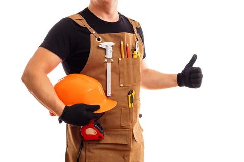 Contractor worker or carpenter in apron with tools and helmet holding thumbs up Stock Photos