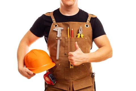 Contractor worker or carpenter in apron with tools and helmet holding thumbs up Stock Photos