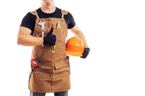 Contractor worker or carpenter in apron with tools and helmet holding thumbs up Stock Photos