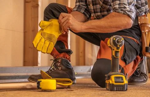 Contractor Worker Preparing to Work by Wearing Protection Gloves Stock Photos