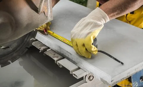 Contractor Worker Taking Measurement While Concrete Cut. Фото