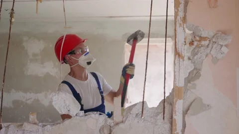 Contractor wrecks wall with sledgehammer making hole for rearrangement. Man Stock Footage 196307847