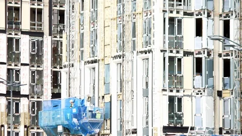 Contractors in outside lift crane elevator platform moving up scaffolding Video stock 115351969