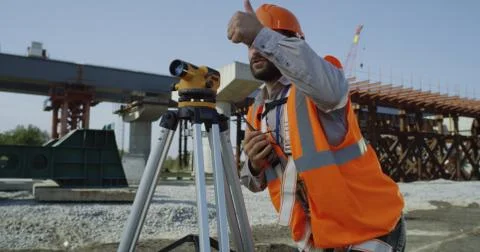 Contractors using theodolite on windy day Stock Photos