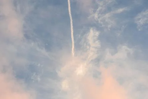 Contrail in Blue Sky with Clouds. Stock-Fotos