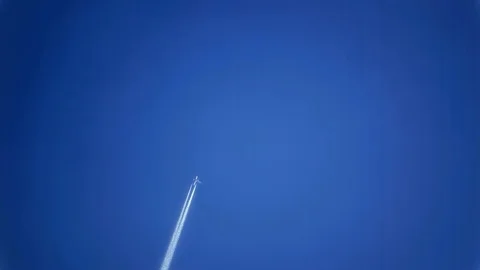 Contrails of Airplane Flying in Nice Clear Blue Sky Stock Footage 102437245