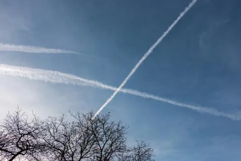 Contrails in the blue sky Stock Photos