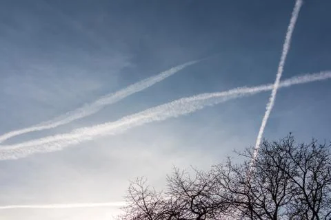 Contrails in the blue sky Stock Photos
