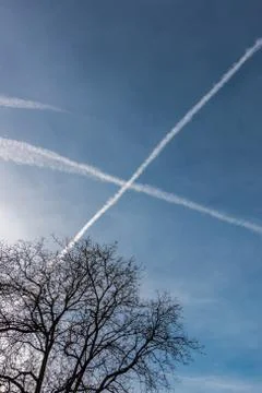 Contrails in the blue sky Stock Photos
