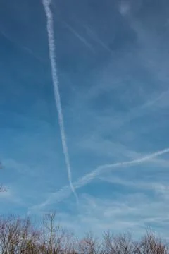 Contrails in the blue sky Stock Photos