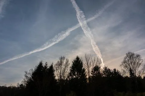 Contrails in the blue sky Stock Photos