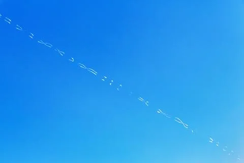 Contrails form patterns in blue sky Santorini Greece Europe Stock Photos