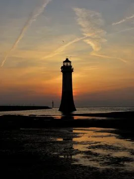 Contrails Over the Lighthouse Stock Photos