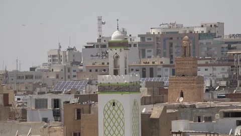 Contrast between historic mosques and modern offices, skyline Sfax Tunisia Stock Footage 334379791