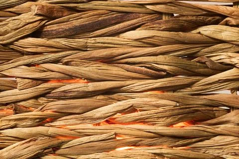 Contrast between the rustic brown fibers and the warm orange glow creates a.. Stock Photos