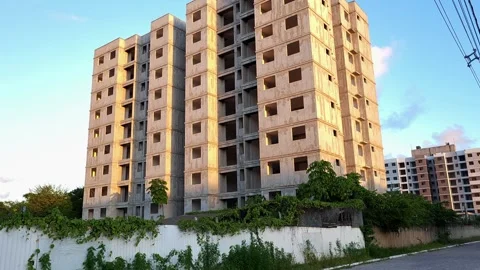 Contrast Between Unfinished Building and Occupied Residential Tower. Stock Footage 326563269