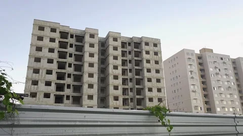 Contrast Between Unfinished Building and Occupied Residential Tower. Stock Footage 326563352