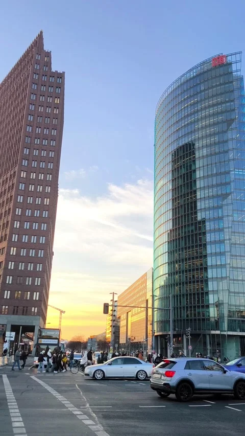 Contrast of modern architecture on Potsdamer Platz, Berlin, at sunset with cars Stock Footage 323674172