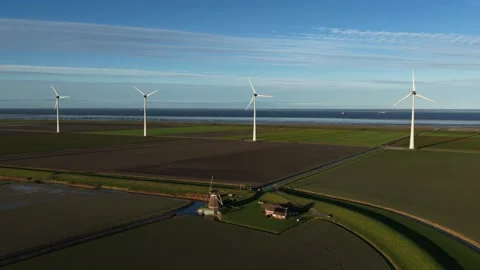Contrast of Old and New Wind Energy Technology in Eemshaven Stock Footage 321785351