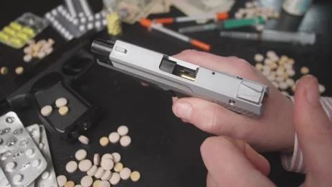 The Contrasting Elements of Modern Society Guns and Drugs, their impact and Stock Footage 293822635