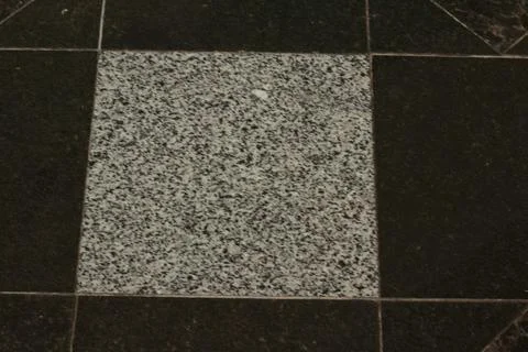 Contrasting Granite Floor Tile Pattern with Light and Dark Stone Stock Photos