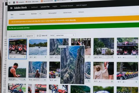 Contributor dashboard for uploading digital stock photos on computer screen. Stockfoto's