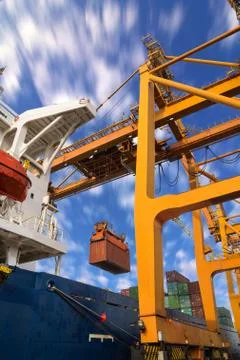 Control cabin in quay crane loading container from containership to container Stock Photos