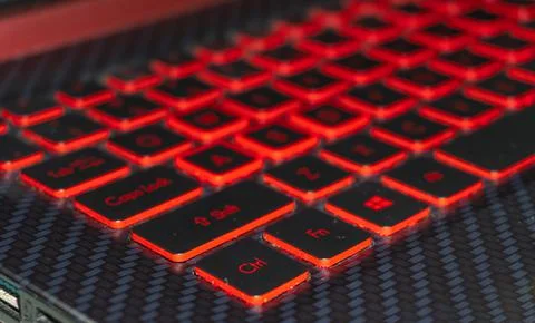 Control function buttons visible on laptop's red keyboard light Stock Photos