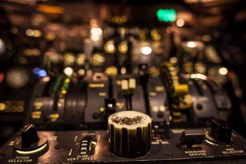Control knobs in airplane cockpit closeup with selective focus Stock Photos