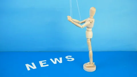 Control a marionette by strings on fingers and word news on blue background,  Stock Footage 131848702