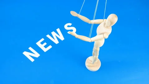 Control a marionette by strings on fingers and word news on blue background,  Stock Footage 139148343