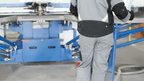 Control of the metal rolling machine by an engineer in a robe Stock Footage 88588315