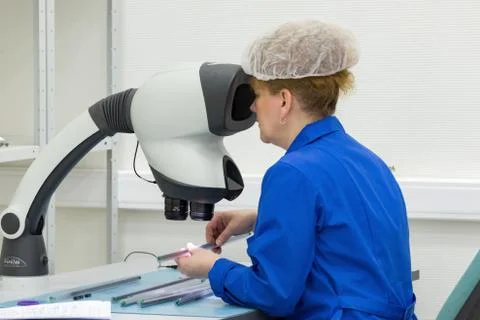 The control operator checks the finished circuit board. Stock Photos