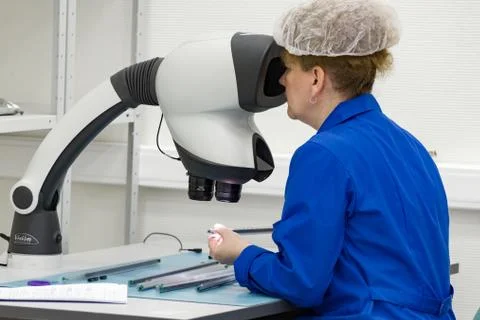 The control operator checks the finished circuit board. Stock Photos
