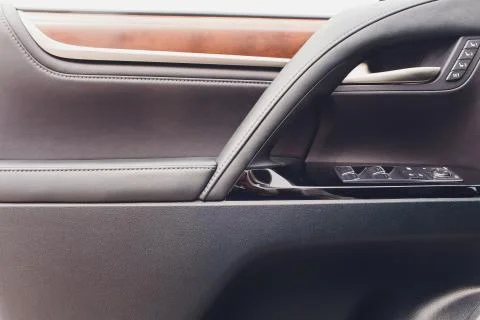Control panel in the car door. Car door handle with adjustment knobs. Stock Photos