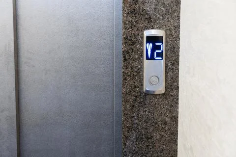 Control panel in a contemporary elevator displays the number two, indicatin.. 库存照片