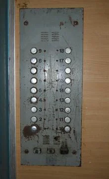 Control panel in the elevator of high-rise building. Buttons worn and scratched Stock Photos