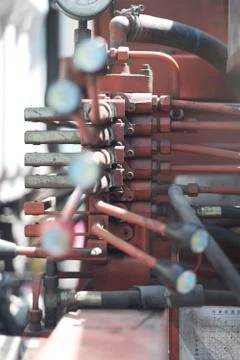 The control panel of the hydraulic unit with levers and pressure gauge Stock Photos